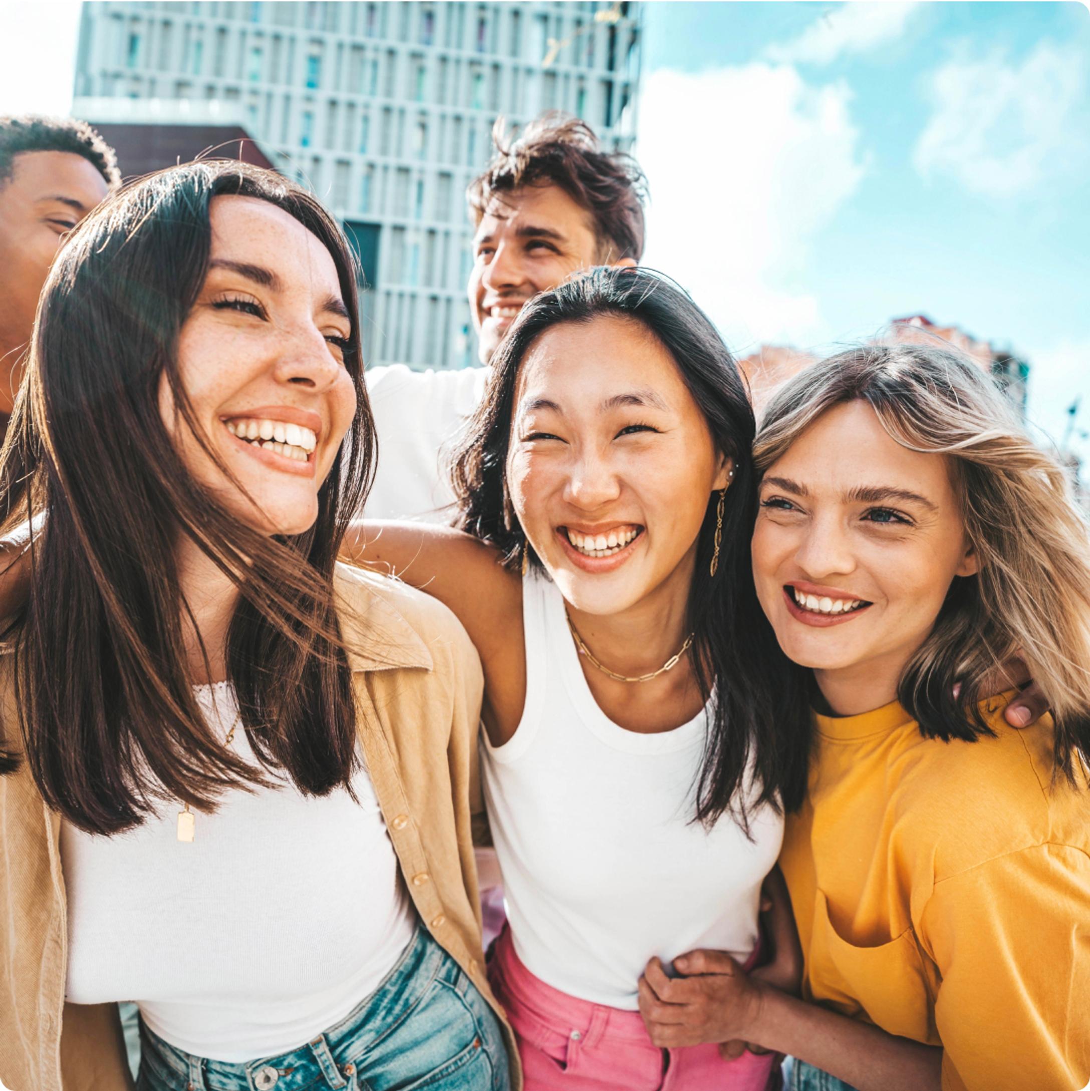 A group of smiling people happy about the referral program of SimplyCodes that let them earn and save money.
